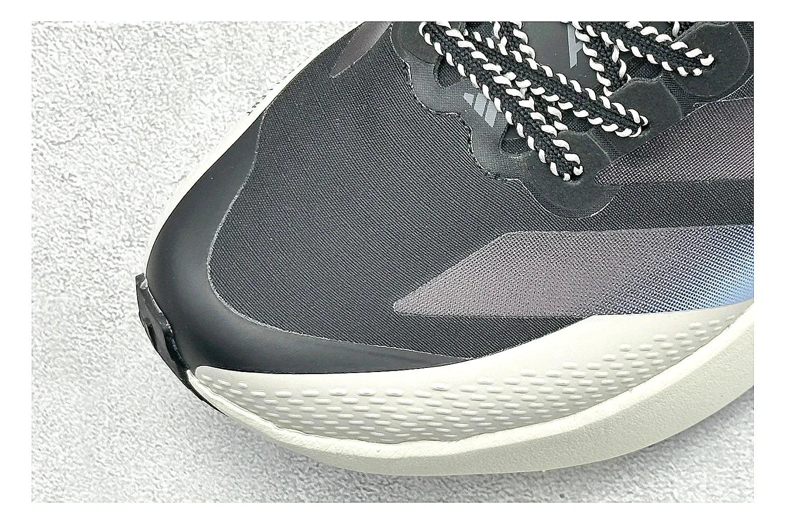 Adidas Adizero Evo Black QC reference photo showing black racing upper, sculpted white sole, Adidas striping, and lightweight performance silhouette thumbnail 4