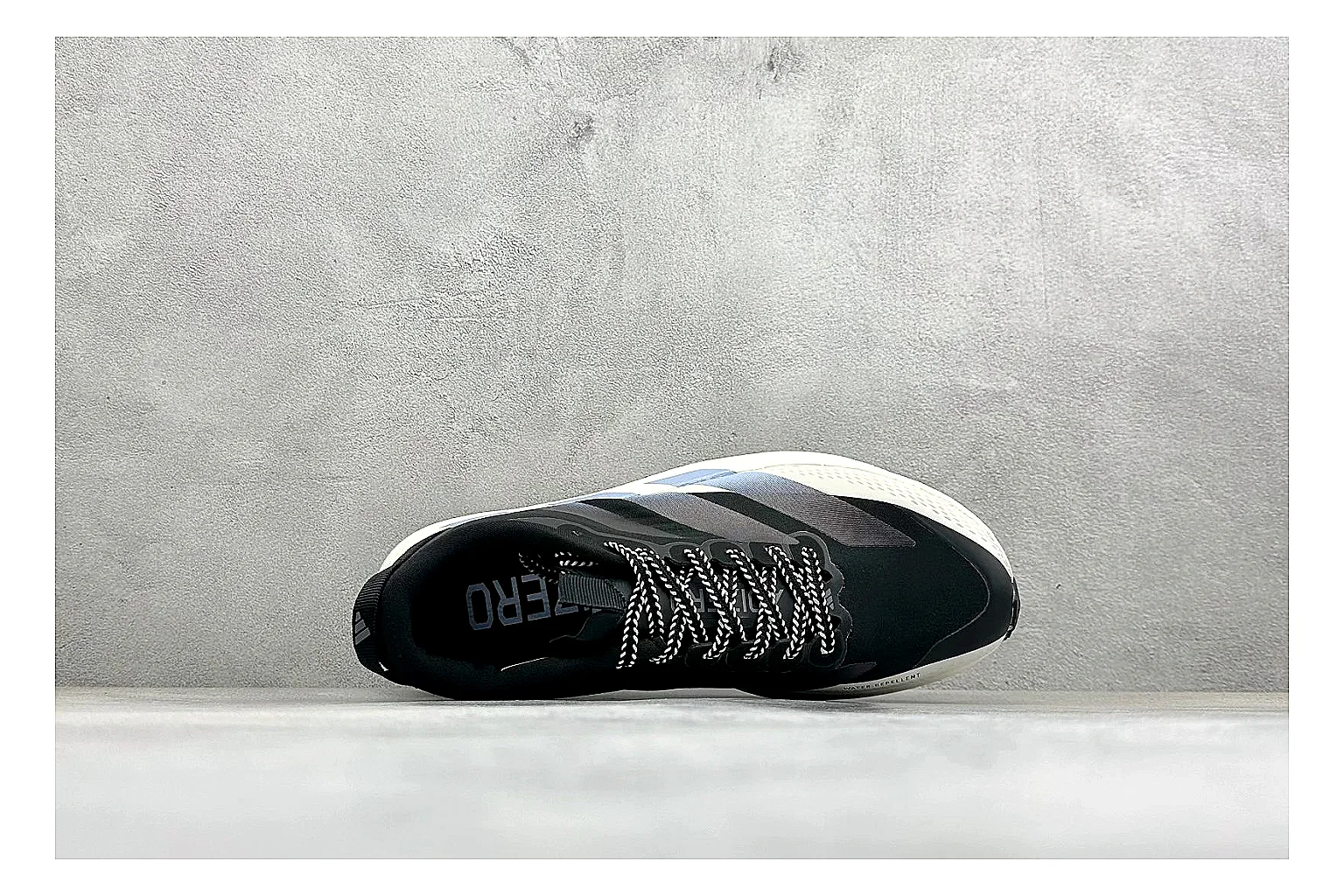 Adidas Adizero Evo Black QC reference photo showing black racing upper, sculpted white sole, Adidas striping, and lightweight performance silhouette thumbnail 6