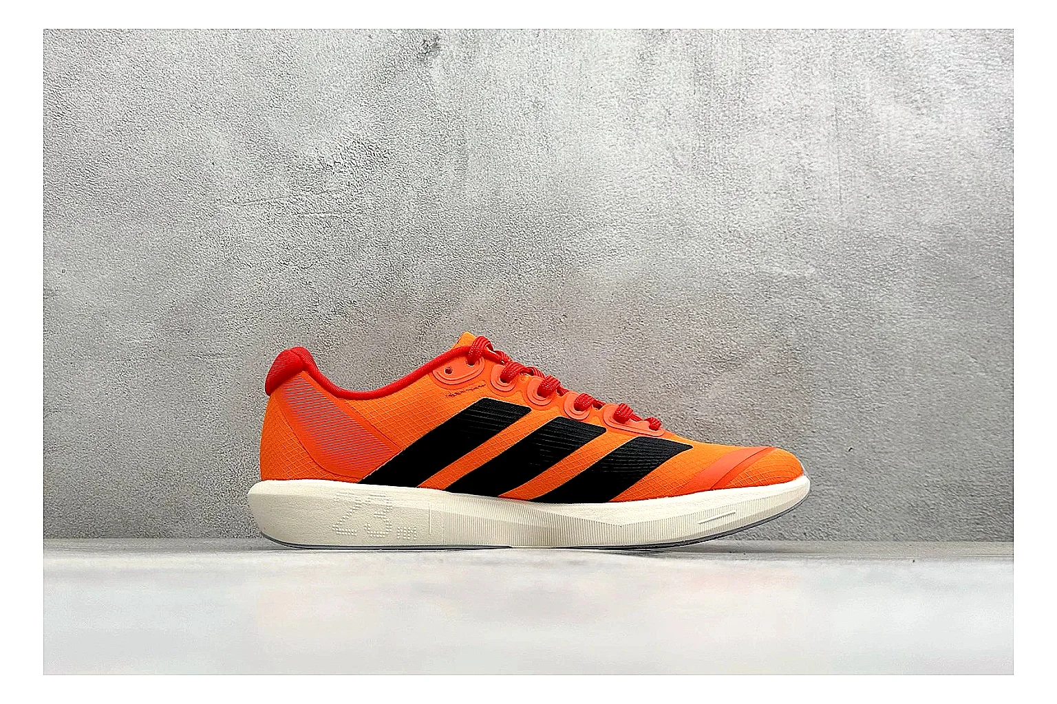 Adidas Adizero Orange Black QC reference photo showing orange runner upper, black three-stripe contrast, lightweight racing shape, and thin performance sole thumbnail 5