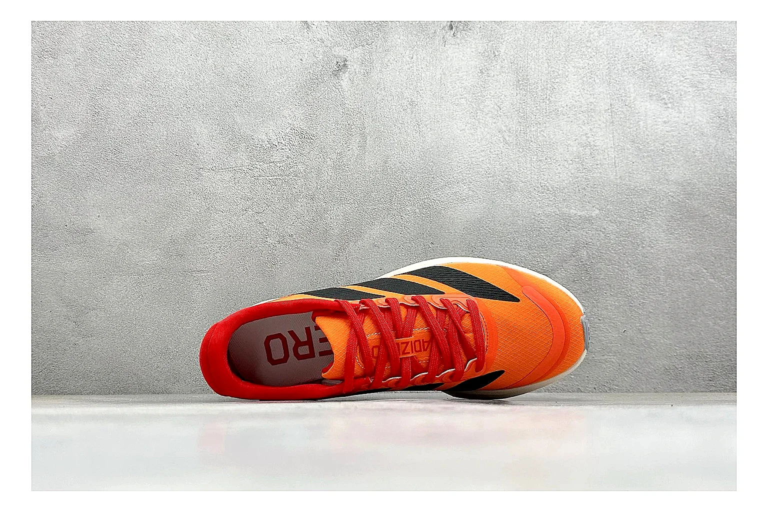 Adidas Adizero Orange Black QC reference photo showing orange runner upper, black three-stripe contrast, lightweight racing shape, and thin performance sole thumbnail 6