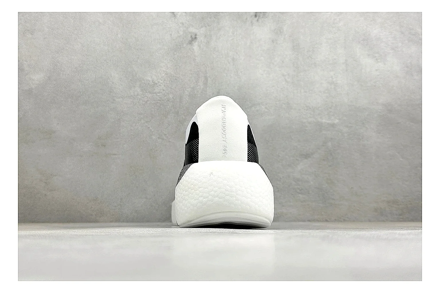 Adidas Hyper Boost White Black QC reference photo showing white knit runner upper, black Adidas striping, sculpted Boost-style sole, and modern low runner profile thumbnail 2