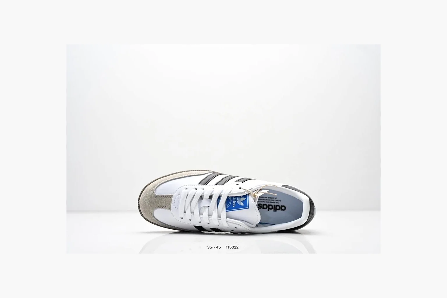 Adidas Samba OG White Black Blue QC reference photo showing white leather-suede low-top upper, black three stripes, blue heel detail, gum terrace sole, and slim Samba profile thumbnail 6
