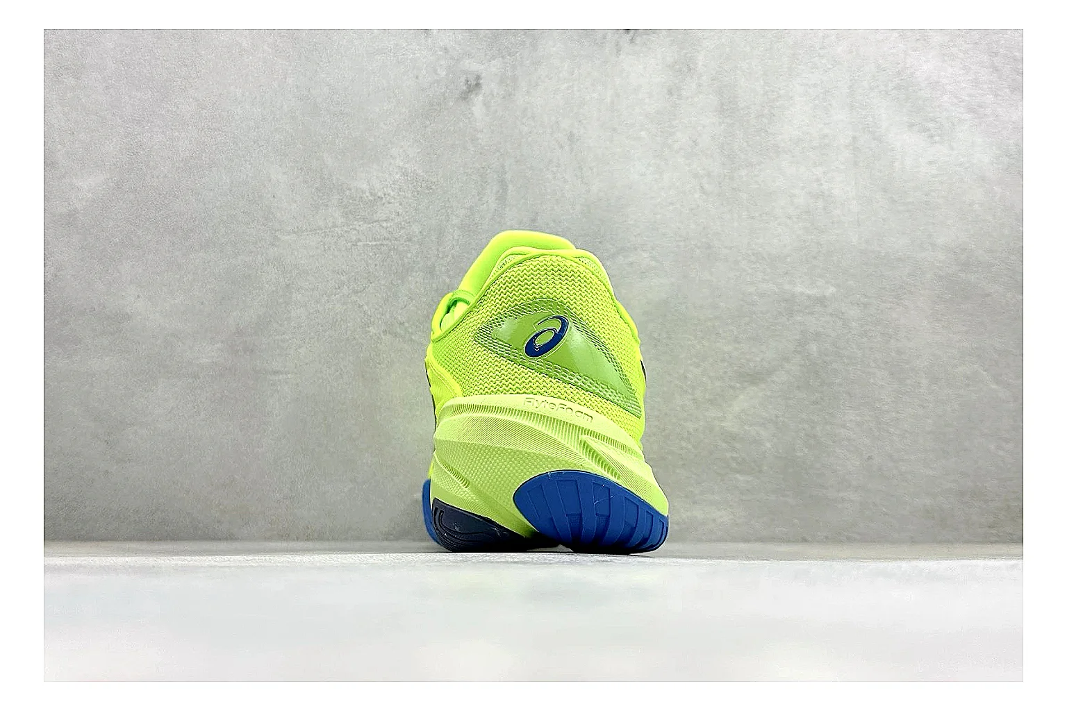 Asics Court FF Volt Blue QC reference photo showing bright volt and blue court upper, supportive sole wall, Asics side lines, and stable tennis profile
