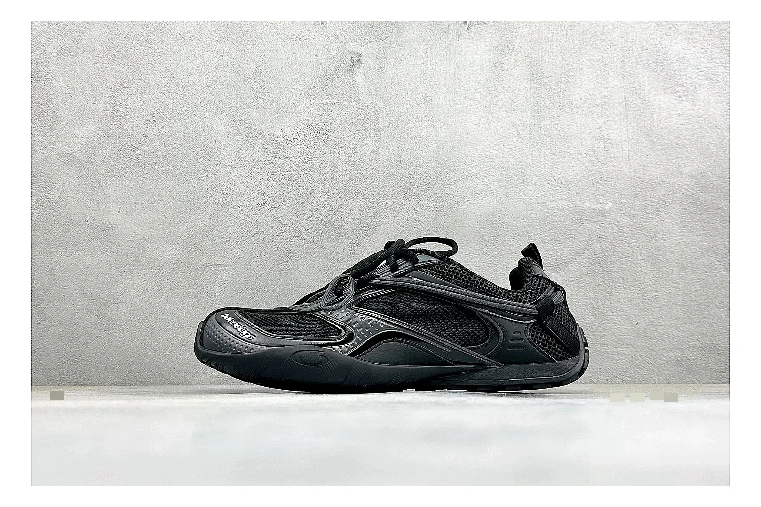 Balenciaga Track Black Low-Top QC reference photo showing black layered technical upper, complex paneling, chunky runner sole, and tactical low-top shape