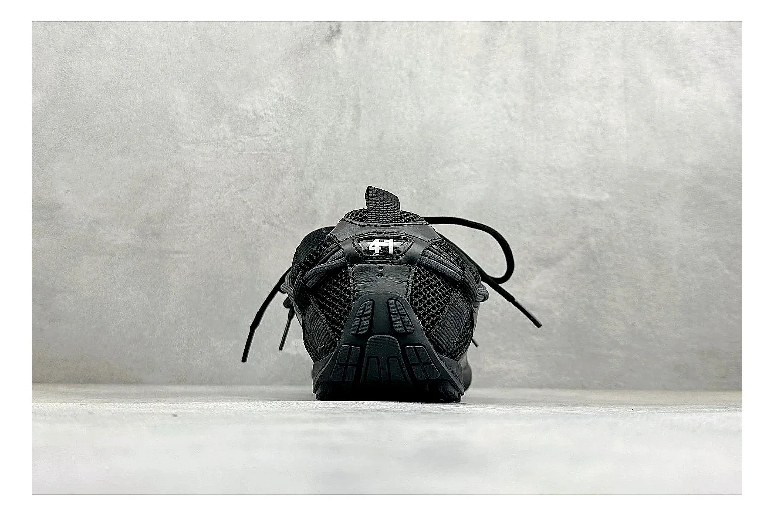 Balenciaga Track Black Low-Top QC reference photo showing black layered technical upper, complex paneling, chunky runner sole, and tactical low-top shape