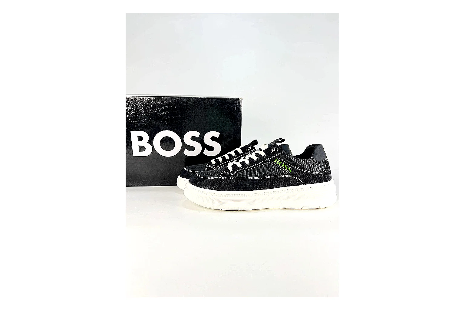 Boss Low Top Black White QC reference photo showing black white leather low-top upper, minimal casual profile, clean panels, and simple rubber sole