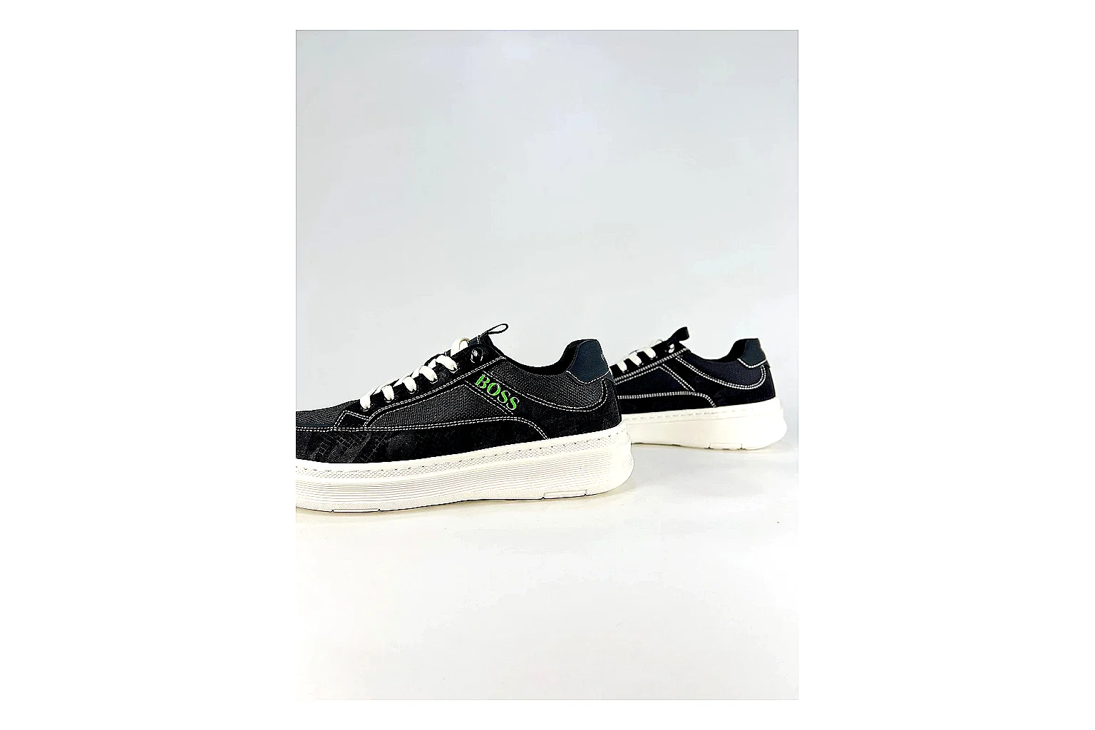 Boss Low Top Black White QC reference photo showing black white leather low-top upper, minimal casual profile, clean panels, and simple rubber sole