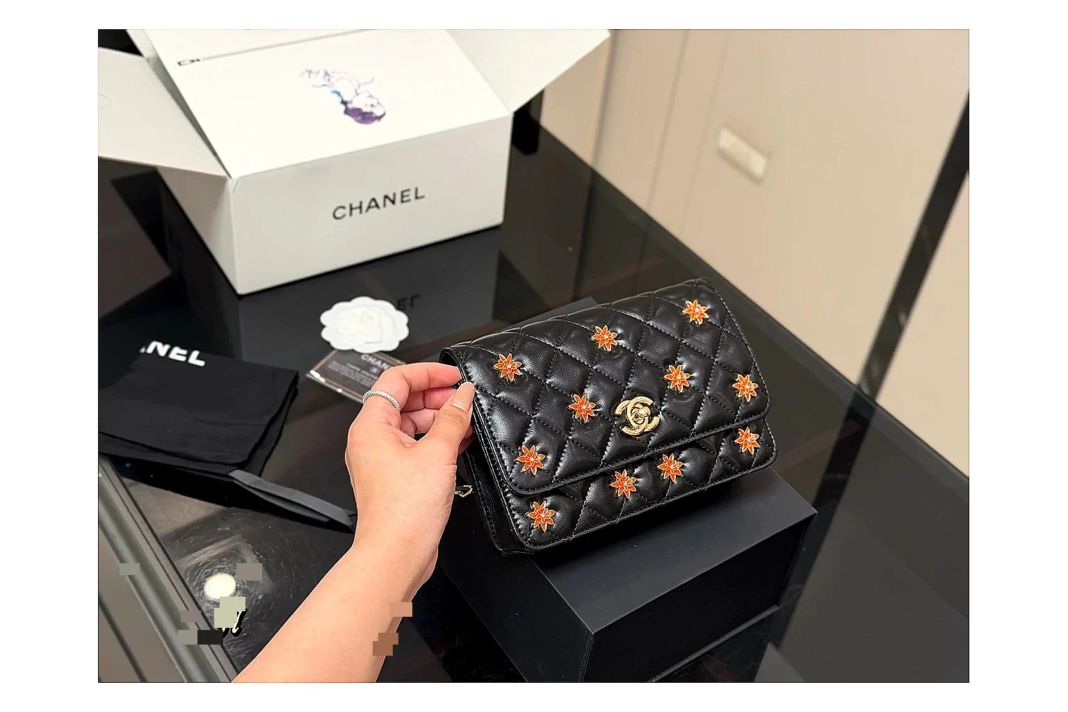 Chanel Quilted Wallet Bag Black Floral QC reference photo showing black quilted wallet-bag body, floral detail, compact flap shape, and polished chain hardware