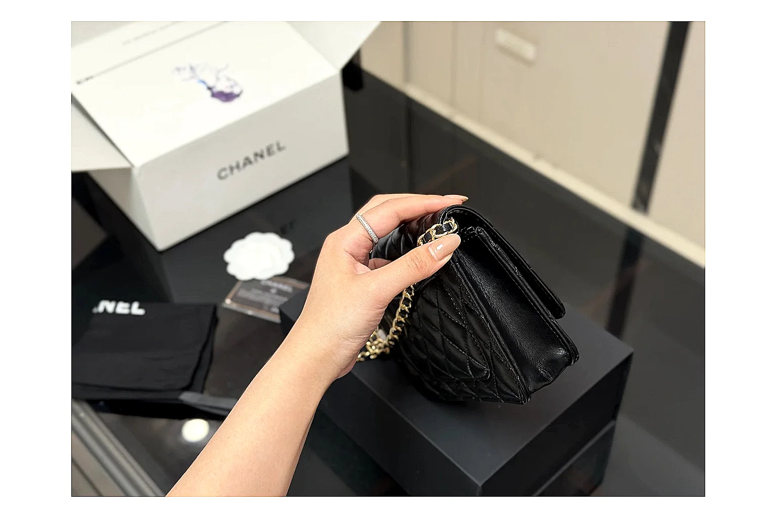 Chanel Quilted Wallet Bag Black Floral QC reference photo showing black quilted wallet-bag body, floral detail, compact flap shape, and polished chain hardware thumbnail 2