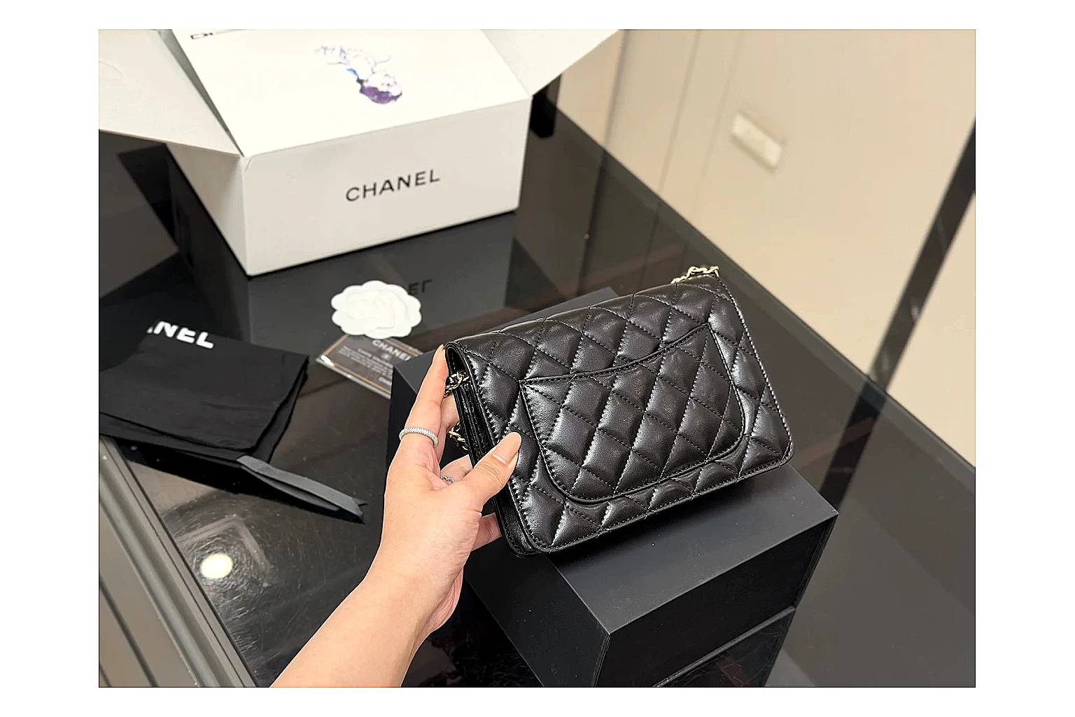 Chanel Quilted Wallet Bag Black Floral QC reference photo showing black quilted wallet-bag body, floral detail, compact flap shape, and polished chain hardware thumbnail 4