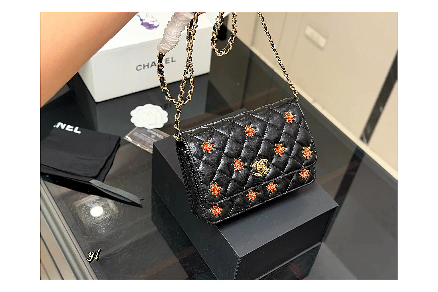 Chanel Quilted Wallet Bag Black Floral QC reference photo showing black quilted wallet-bag body, floral detail, compact flap shape, and polished chain hardware thumbnail 5