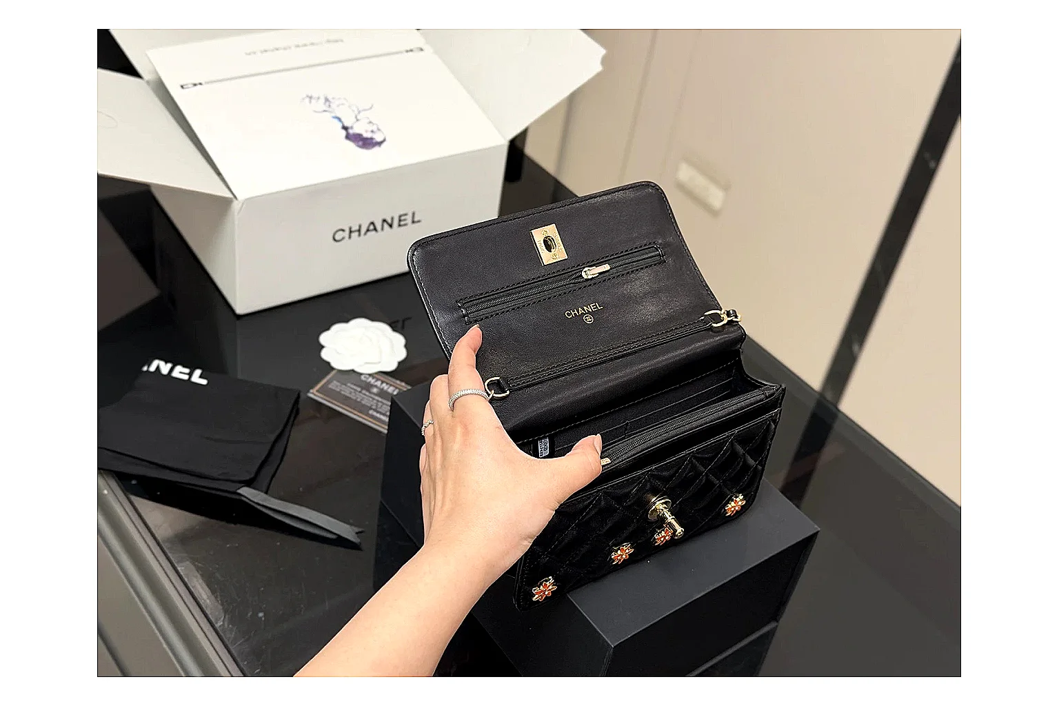 Chanel Quilted Wallet Bag Black Floral QC reference photo showing black quilted wallet-bag body, floral detail, compact flap shape, and polished chain hardware thumbnail 6