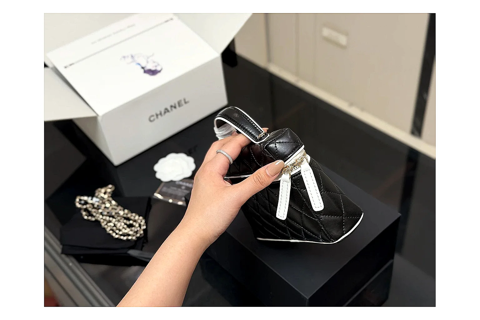Chanel Wallet On Chain Black QC reference photo showing black quilted leather wallet body, chain strap, flap closure, and compact shoulder-bag profile