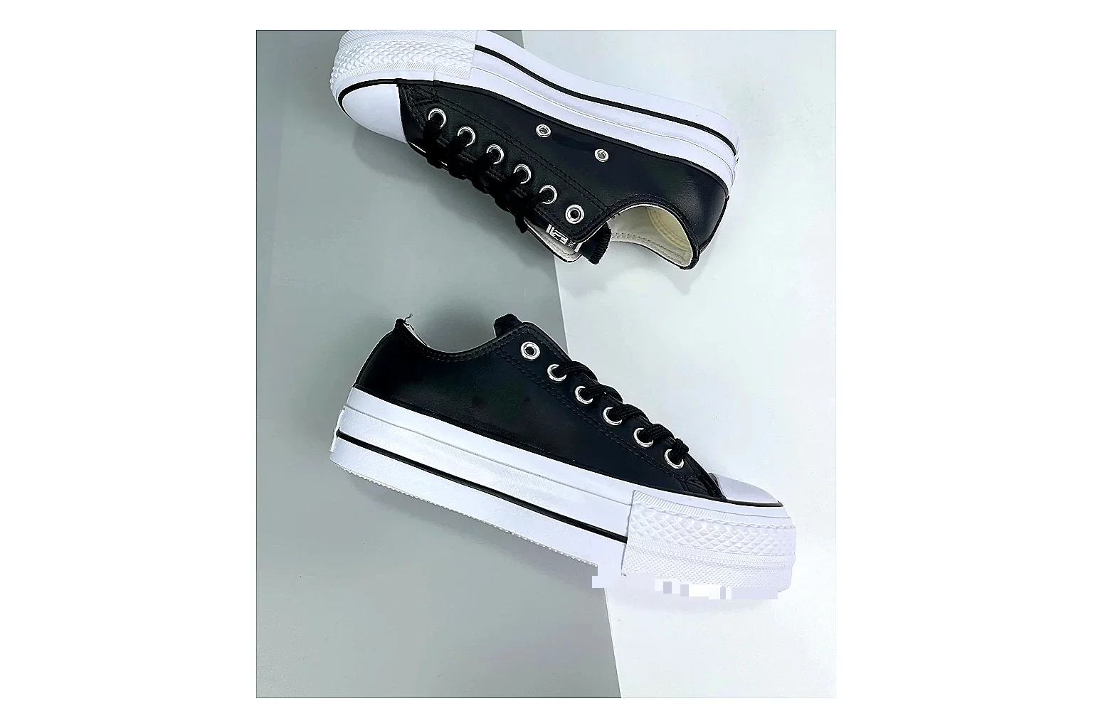 Converse All Star Lift Black Platform Low Top QC reference photo showing black leather low-top upper, silver eyelets, white rubber toe cap, and elevated striped platform sole