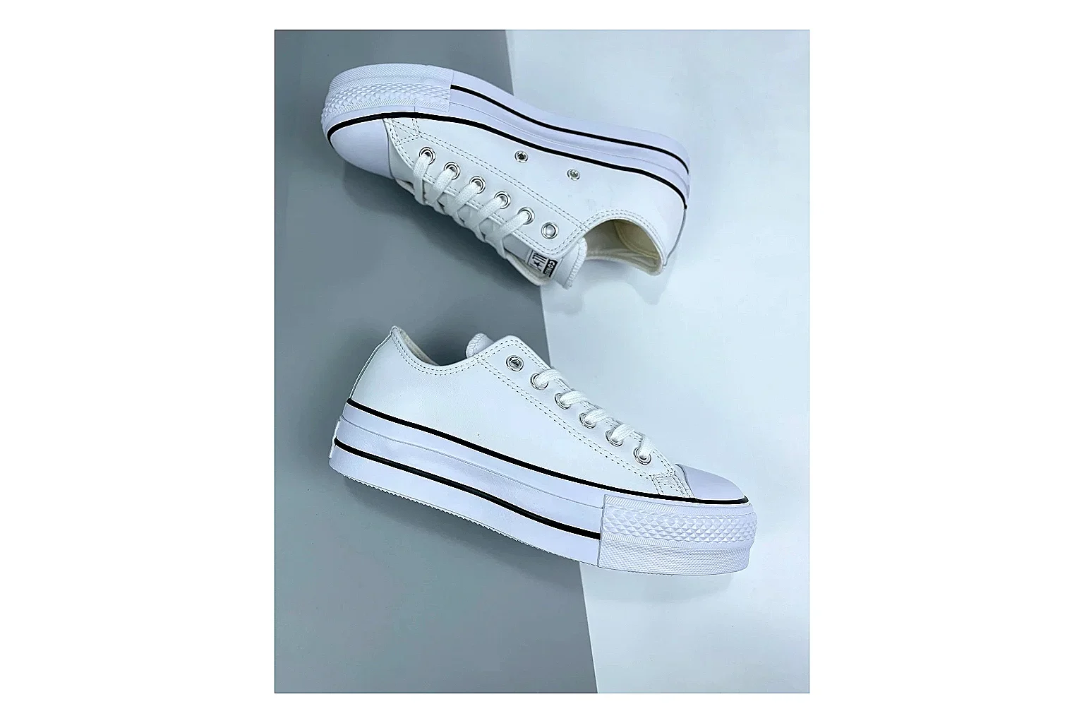 Converse All Star Lift White Platform Low Top QC reference photo showing white smooth low-top upper, silver eyelets, black foxing stripes, and elevated platform rubber sole
