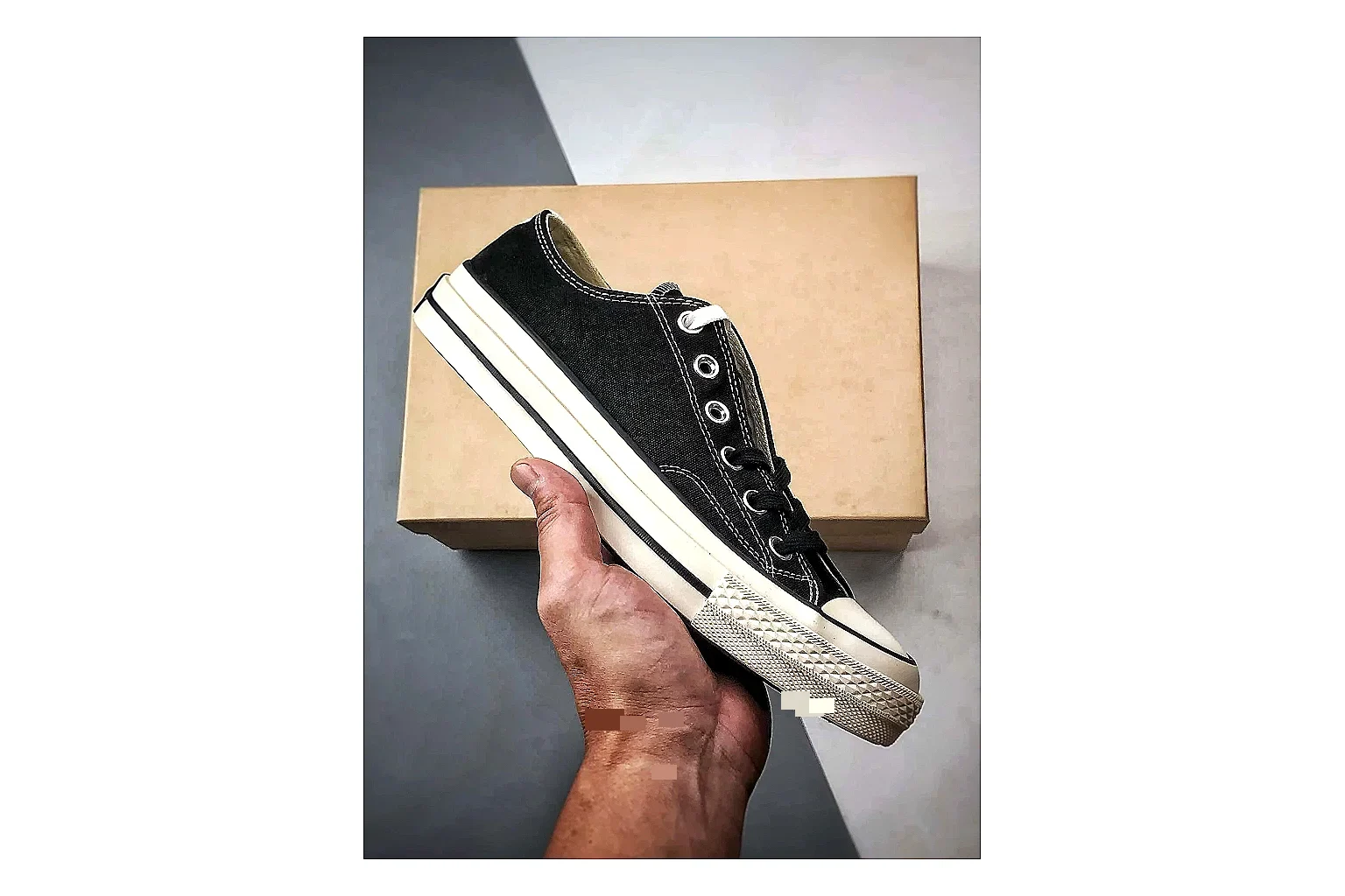 Converse Chuck Low Black White QC reference photo showing black canvas low-top upper, white rubber toe cap, metal eyelets, and classic Converse sole