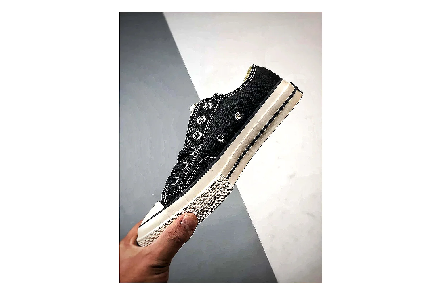 Converse Chuck Low Black White QC reference photo showing black canvas low-top upper, white rubber toe cap, metal eyelets, and classic Converse sole
