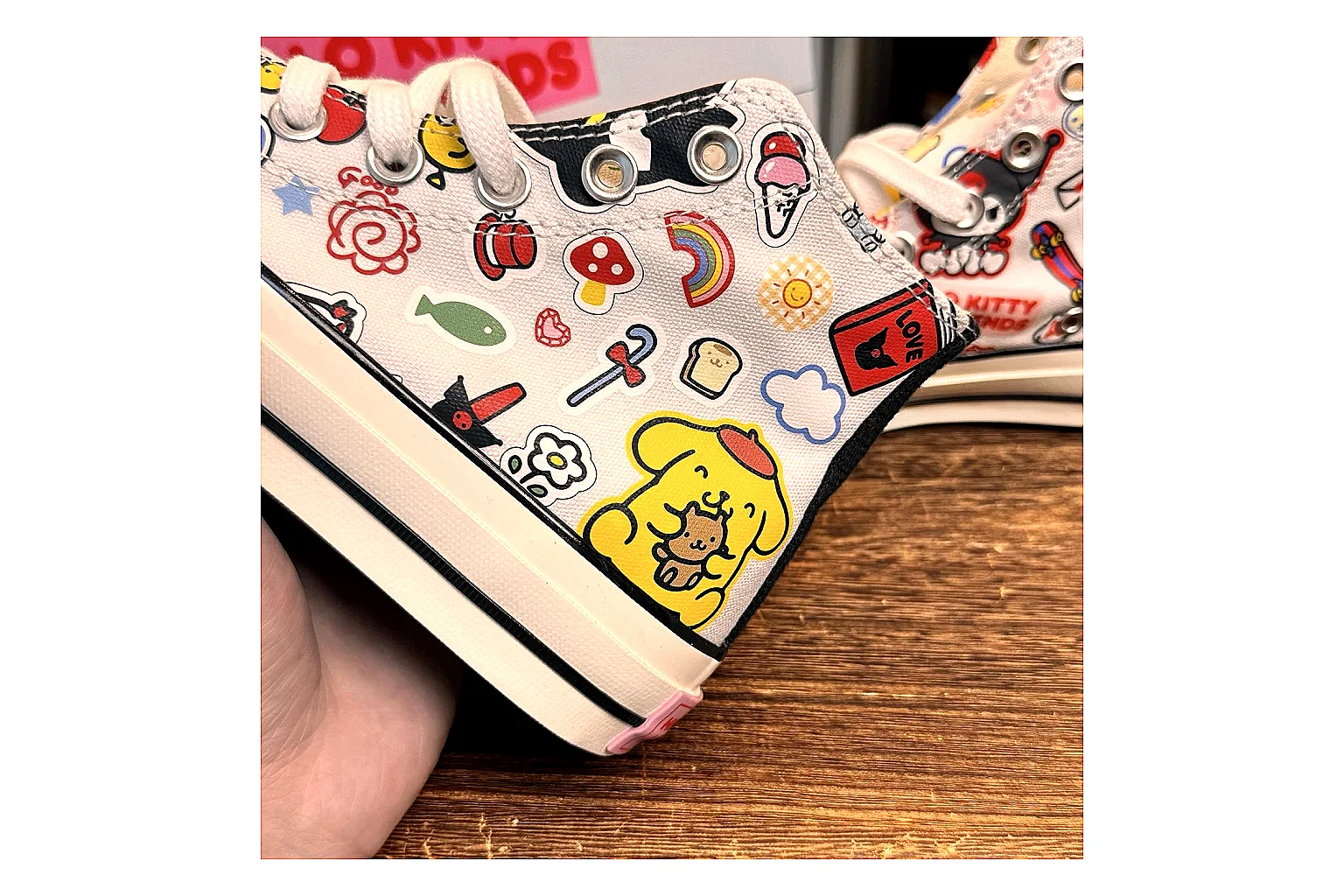 Converse Hello Kitty Chuck 70 High Top QC reference photo showing white canvas high-top upper, colorful character graphics, metal eyelets, rubber toe cap, and elevated vintage sole thumbnail 4