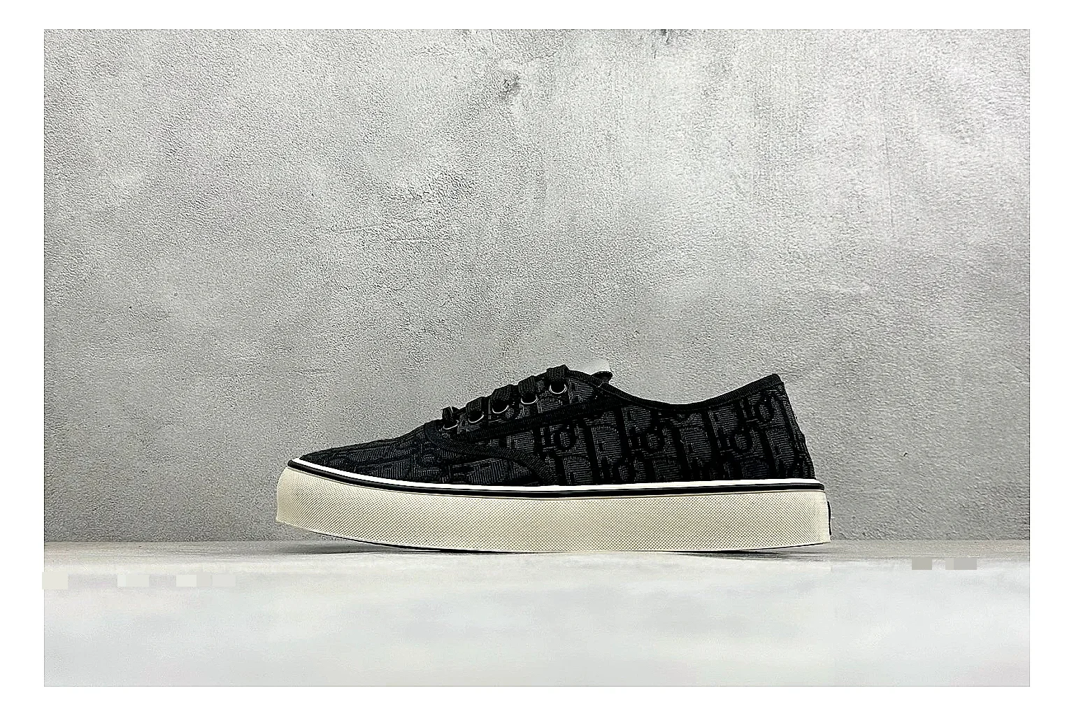 Dior Act Slide Black Low-Top QC reference photo showing black monogram-style upper, low slip-on shape, chunky dark sole, and luxury casual profile
