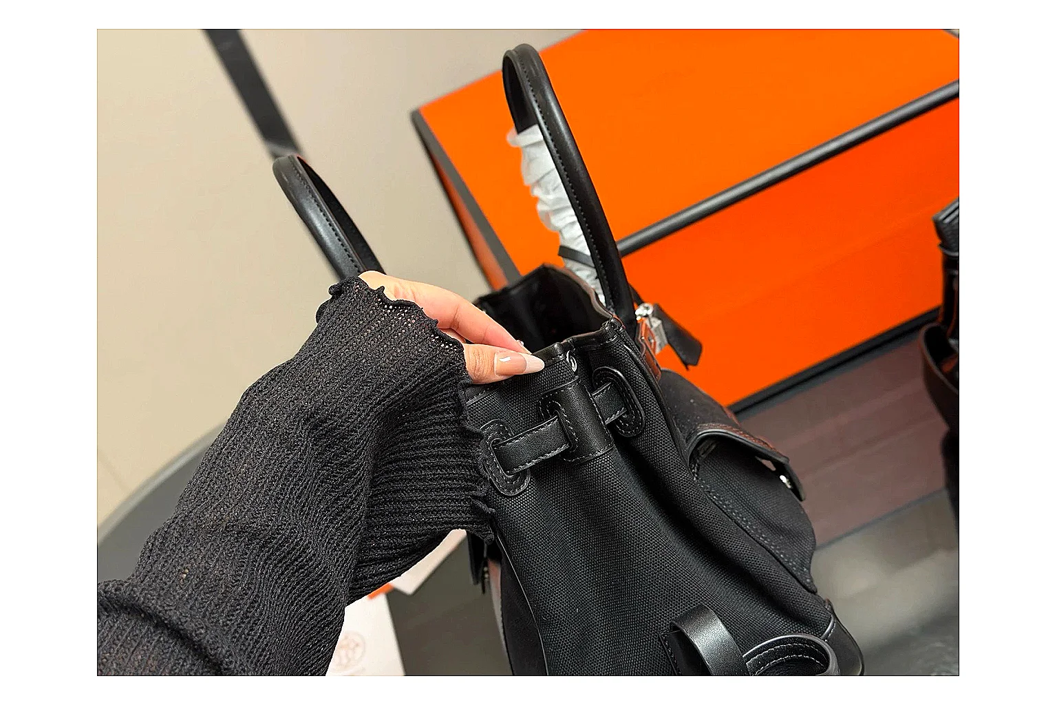 Hermes Birkin Style Black QC reference photo showing black leather structured body, top handles, flap-and-strap shape, and polished hardware