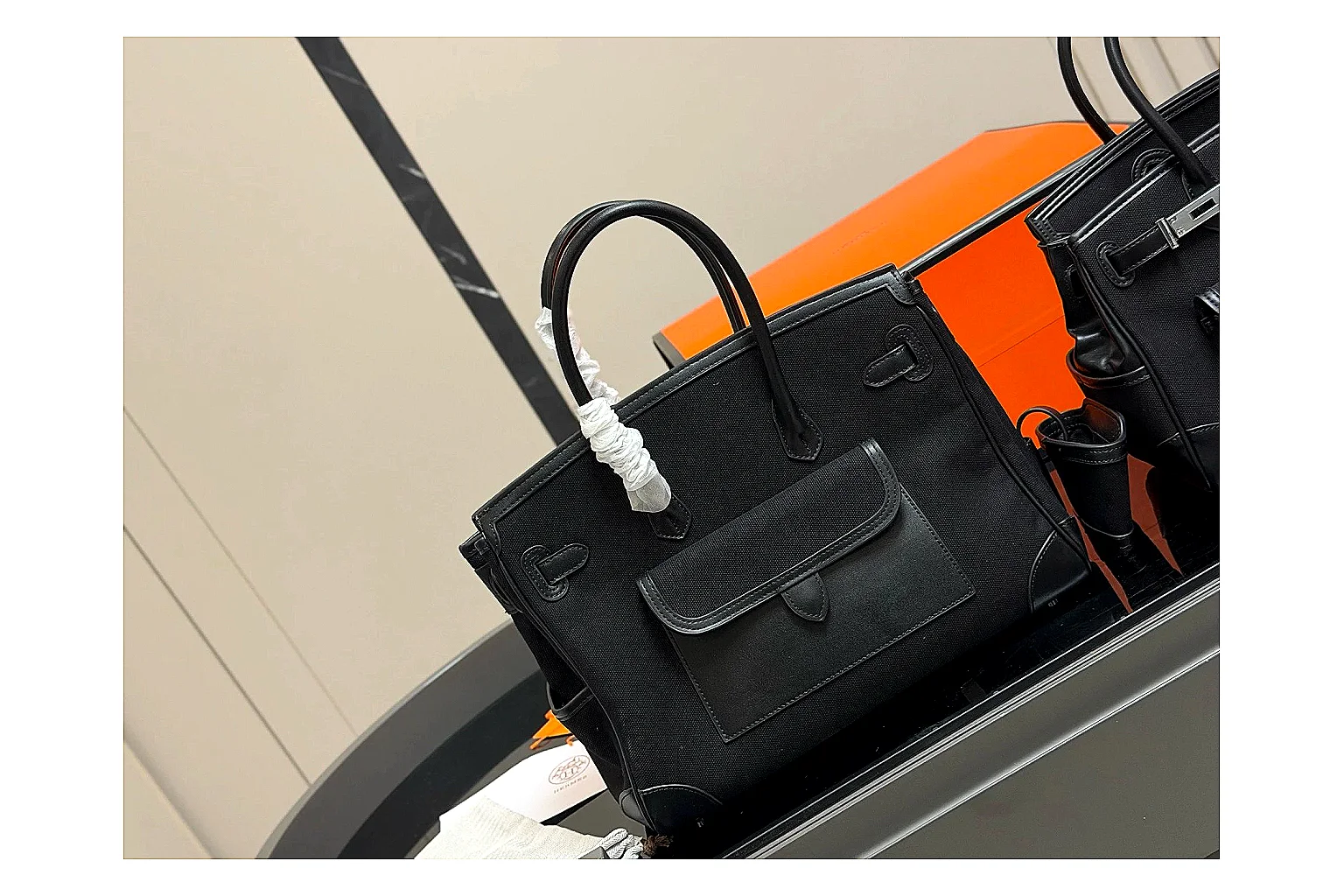 Hermes Birkin Style Black QC reference photo showing black leather structured body, top handles, flap-and-strap shape, and polished hardware thumbnail 4