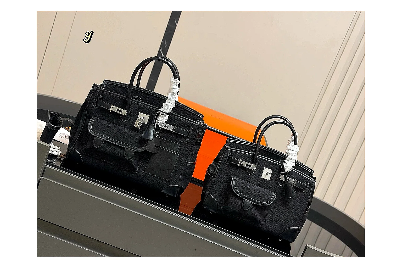 Hermes Birkin Style Black QC reference photo showing black leather structured body, top handles, flap-and-strap shape, and polished hardware thumbnail 5