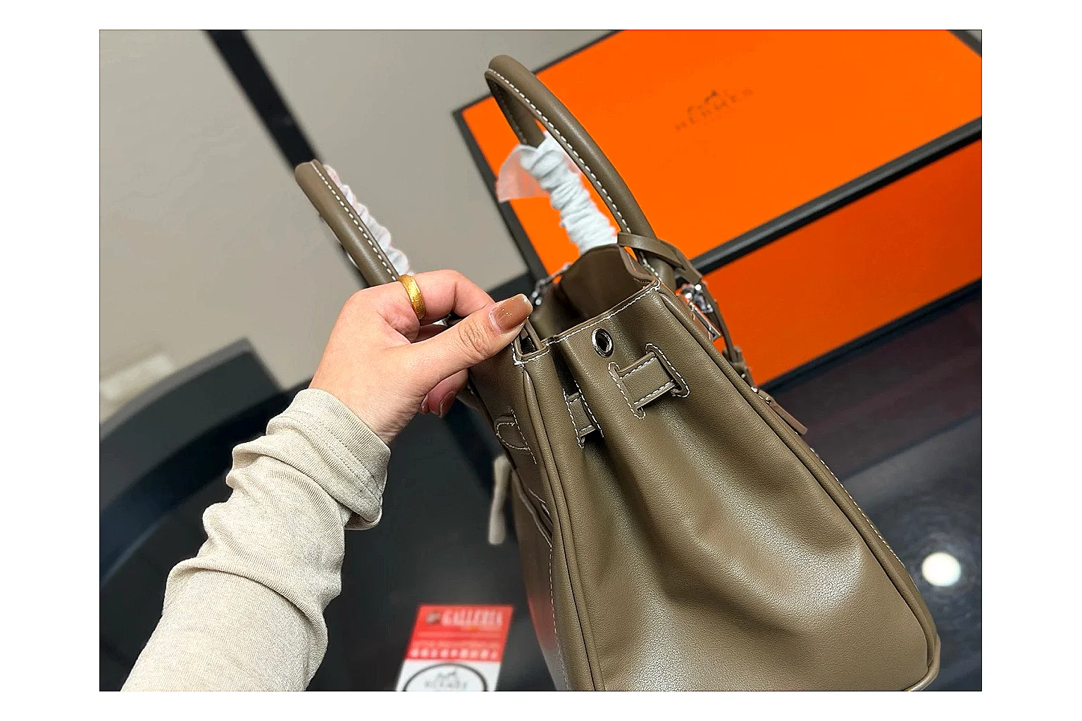 Hermes Birkin Style Olive QC reference photo showing olive leather structured body, top handles, flap-and-strap shape, and polished hardware