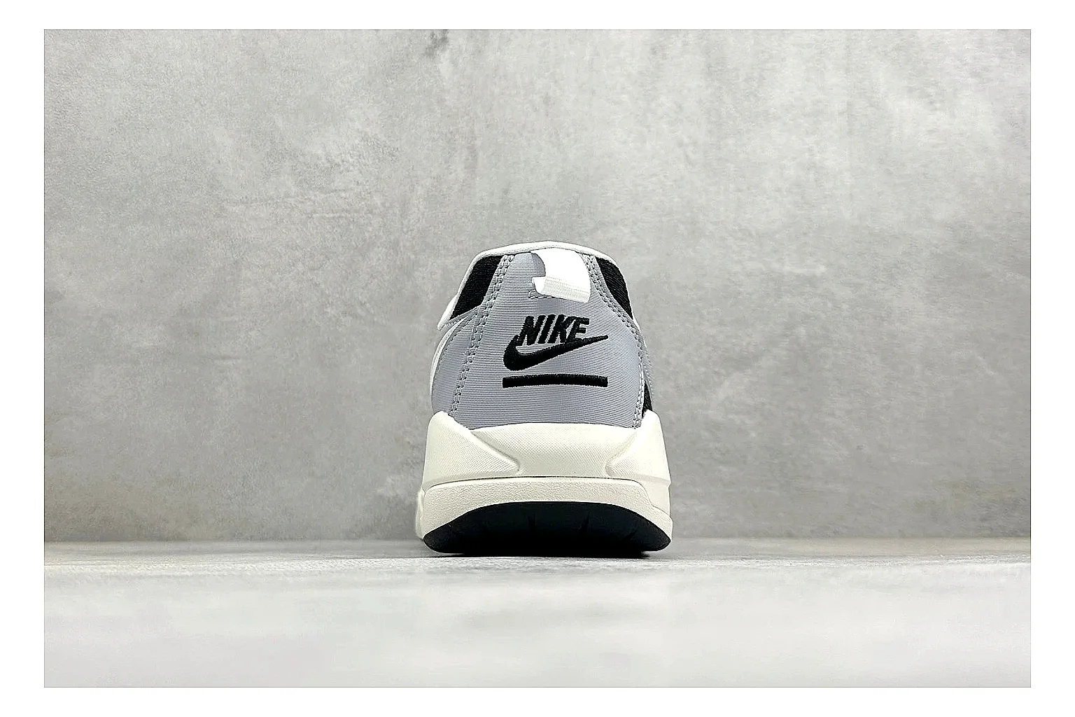 Jordan CMFT Black White QC reference photo showing black and white layered panels, low padded collar, visible Jordan styling cues, and a compact court sole