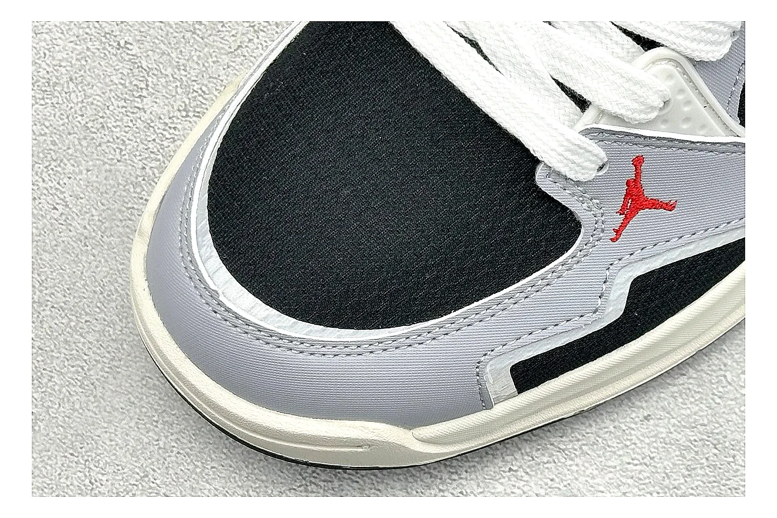 Jordan CMFT Black White QC reference photo showing black and white layered panels, low padded collar, visible Jordan styling cues, and a compact court sole thumbnail 4