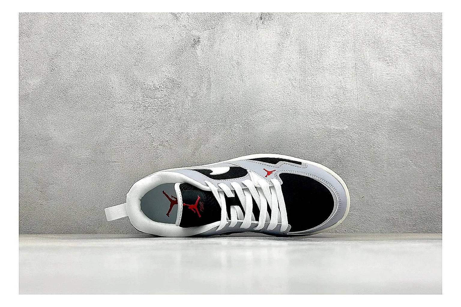Jordan CMFT Black White QC reference photo showing black and white layered panels, low padded collar, visible Jordan styling cues, and a compact court sole thumbnail 6