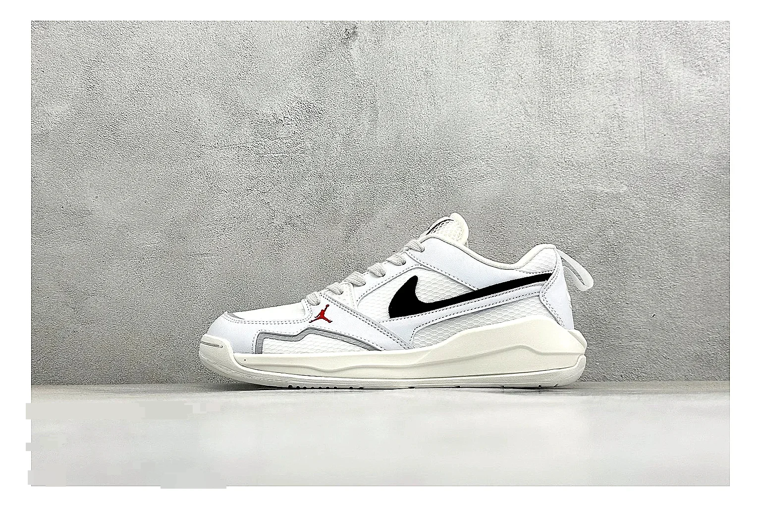 Jordan CMFT White Black QC reference photo showing white and black layered court panels, red logo detail, low collar, and a clean contrast sole