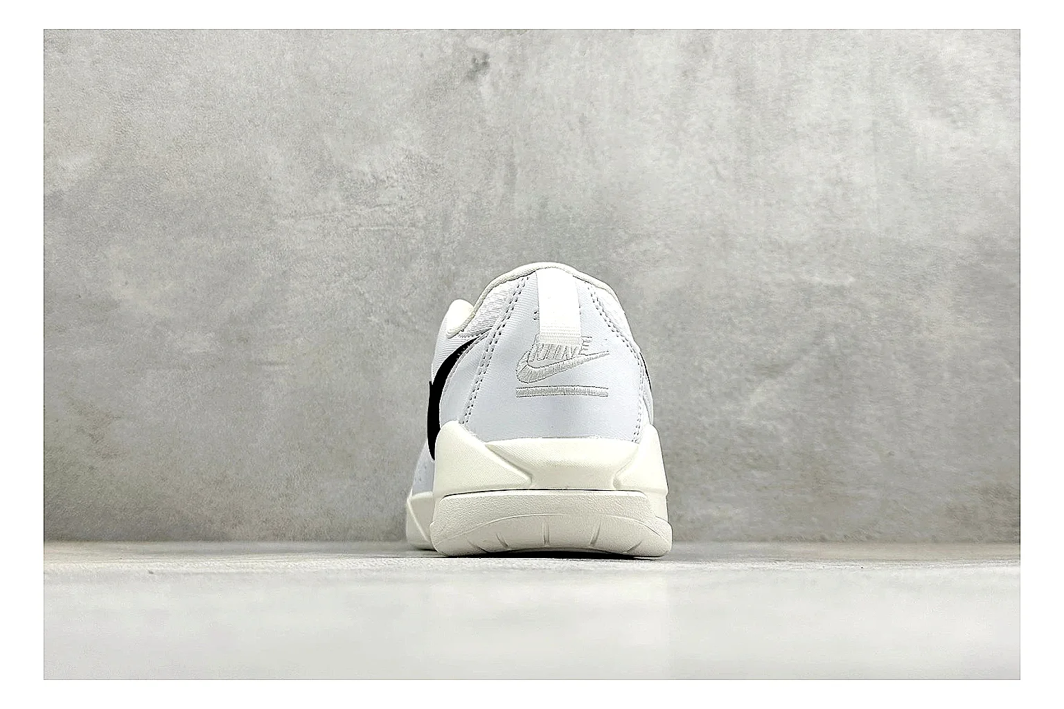 Jordan CMFT White Black QC reference photo showing white and black layered court panels, red logo detail, low collar, and a clean contrast sole