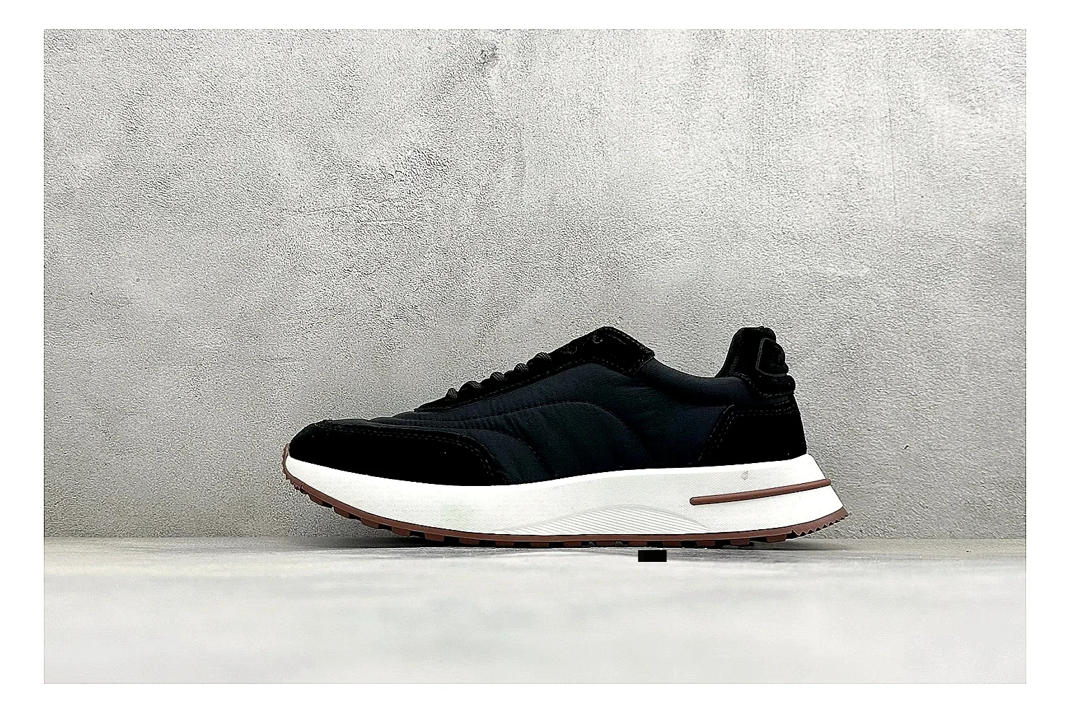 Loro Piana Week-End Black QC reference image showing black suede upper, low casual profile, striped midsole accent, and soft everyday shape