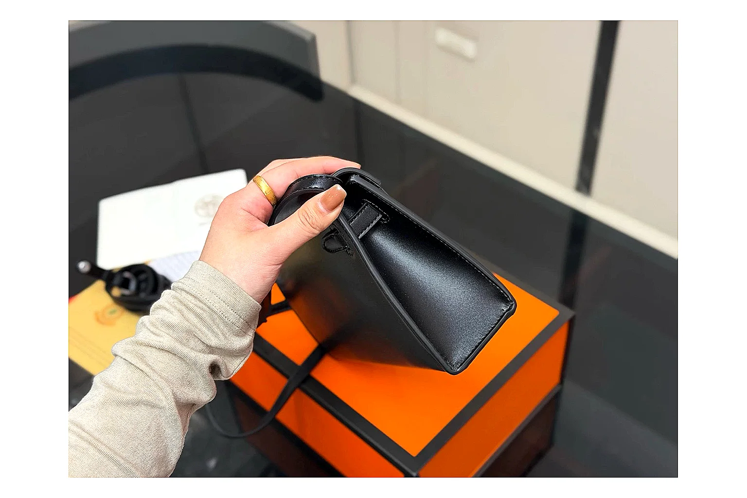 Louis Vuitton Wallet On Chain Black QC reference photo showing black leather wallet-bag body, compact flap shape, chain strap, and polished LV-style hardware