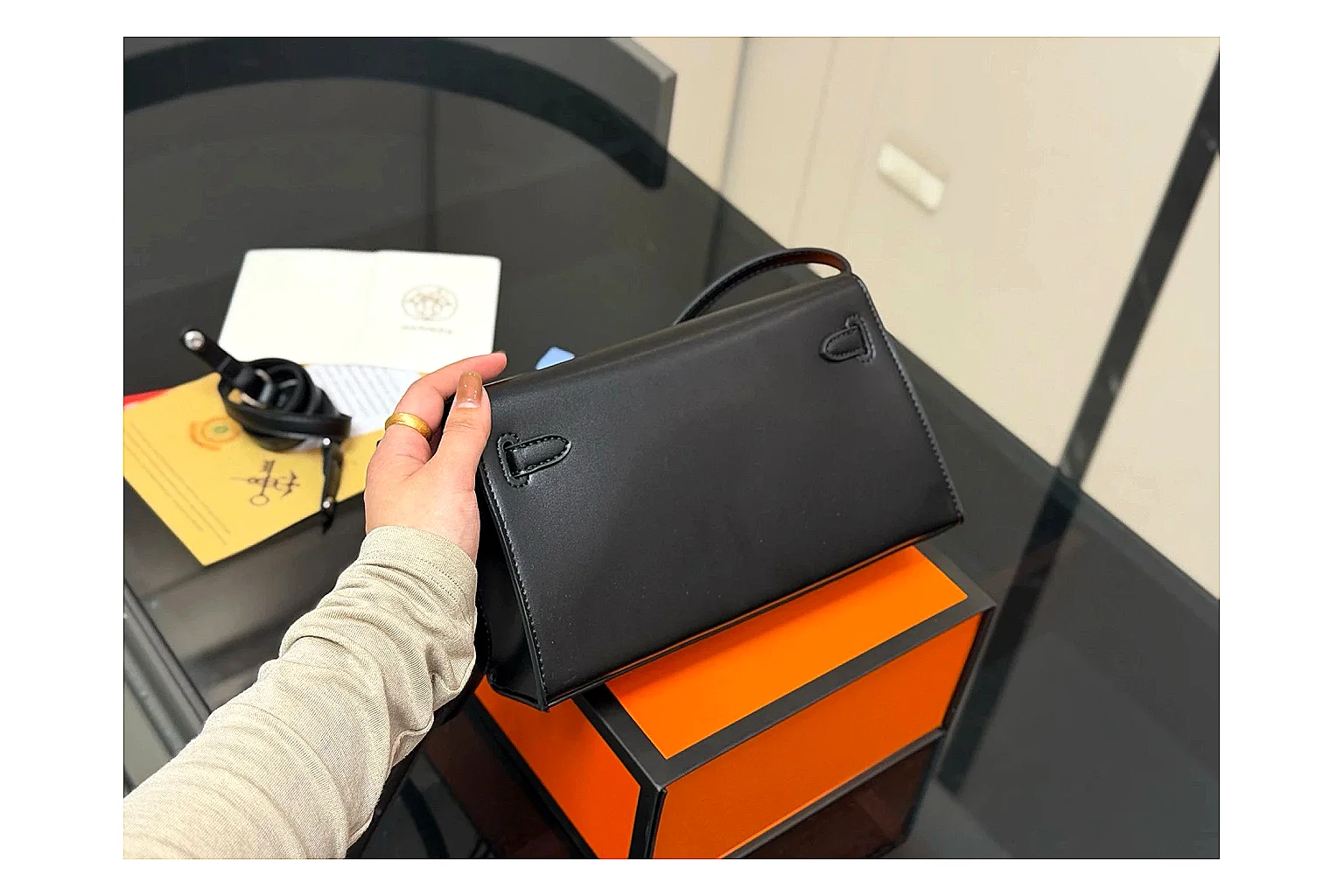 Louis Vuitton Wallet On Chain Black QC reference photo showing black leather wallet-bag body, compact flap shape, chain strap, and polished LV-style hardware thumbnail 4
