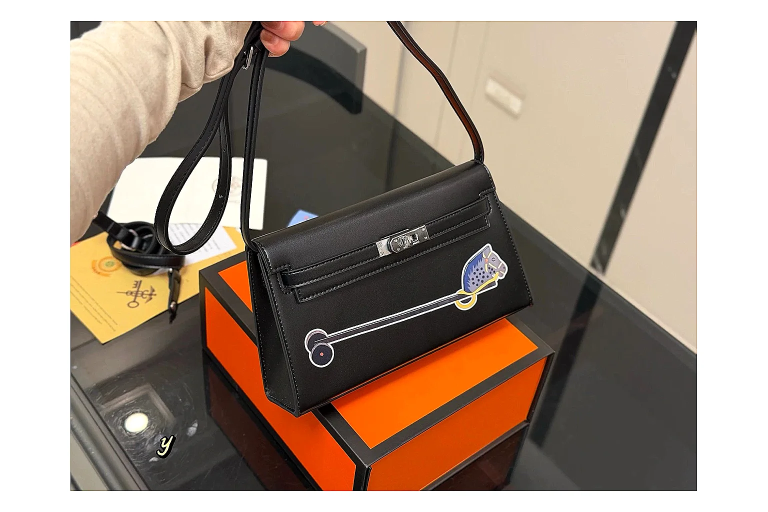 Louis Vuitton Wallet On Chain Black QC reference photo showing black leather wallet-bag body, compact flap shape, chain strap, and polished LV-style hardware thumbnail 5