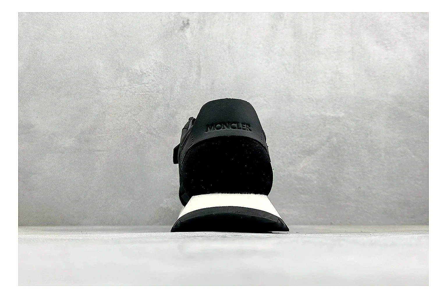 Moncler Pacey Black White QC reference image showing black upper, white rugged outsole, low padded collar, and outdoor-leaning tread profile