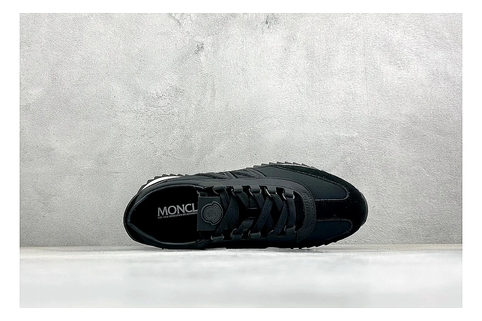 Moncler Pacey Black White QC reference image showing black upper, white rugged outsole, low padded collar, and outdoor-leaning tread profile thumbnail 6