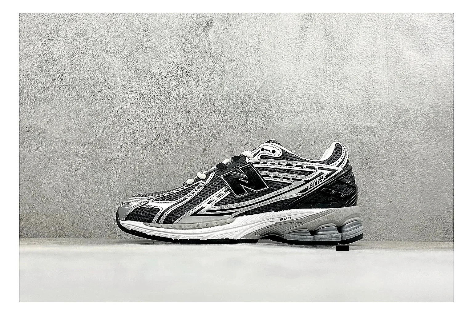 New Balance 1906 Black Silver QC reference photo showing black mesh base, silver overlays, technical 1906 runner structure, and layered performance sole