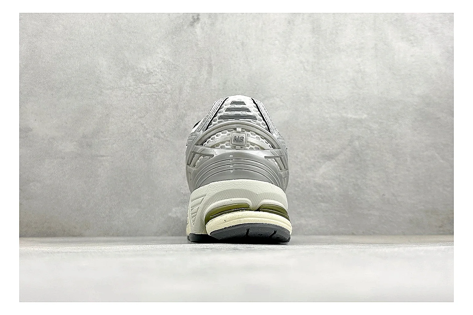 New Balance 1906 Silver Grey QC reference image showing silver overlays, grey mesh panels, technical runner structure, and layered midsole tooling