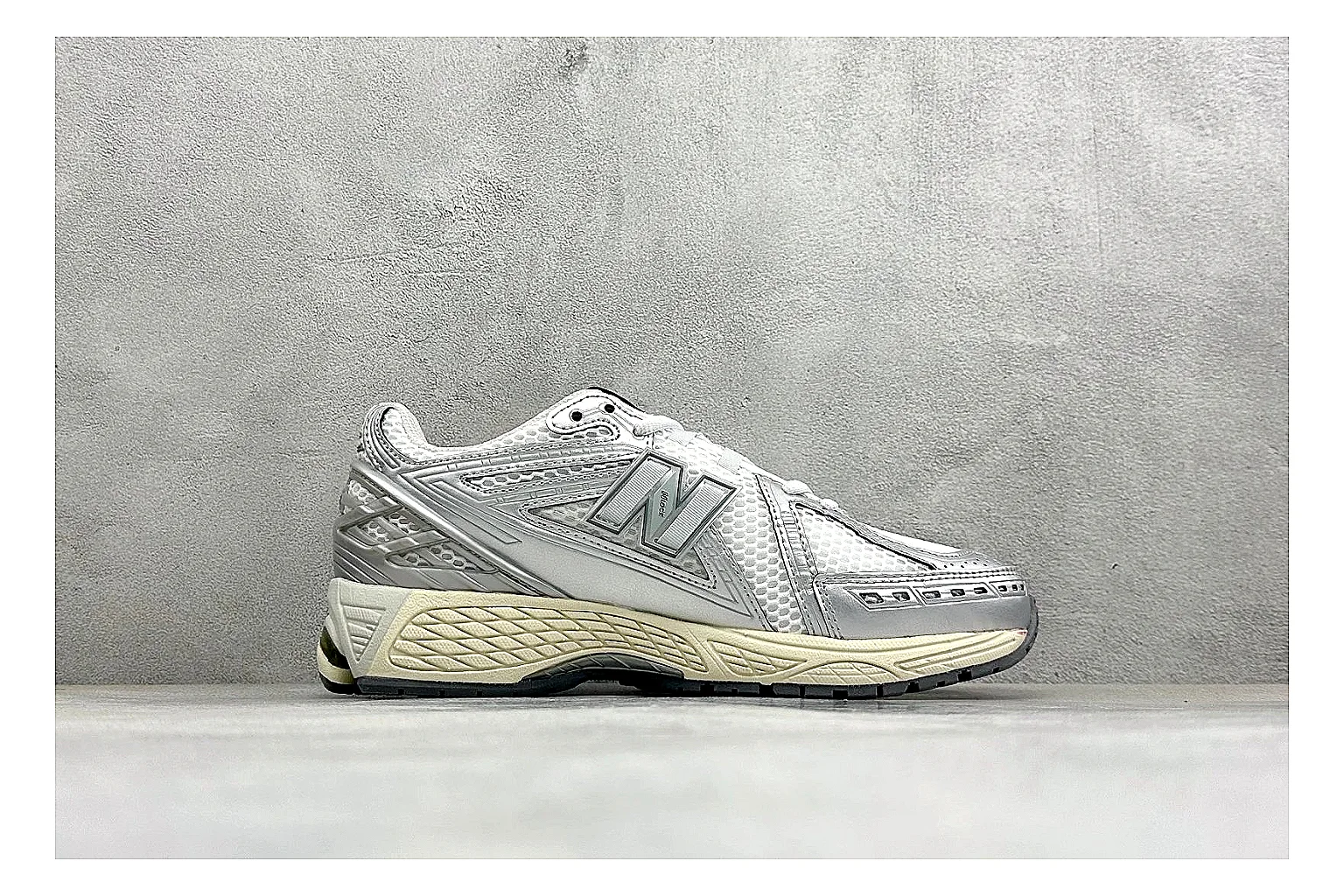New Balance 1906 Silver Grey QC reference image showing silver overlays, grey mesh panels, technical runner structure, and layered midsole tooling thumbnail 5