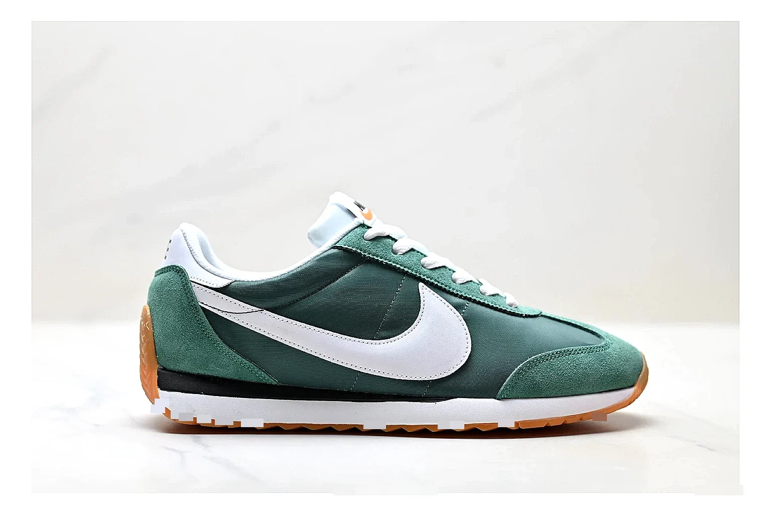 Nike Cortez Green White QC reference photo showing green white leather low-top upper, slim retro runner profile, Swoosh detail, and classic Cortez sole