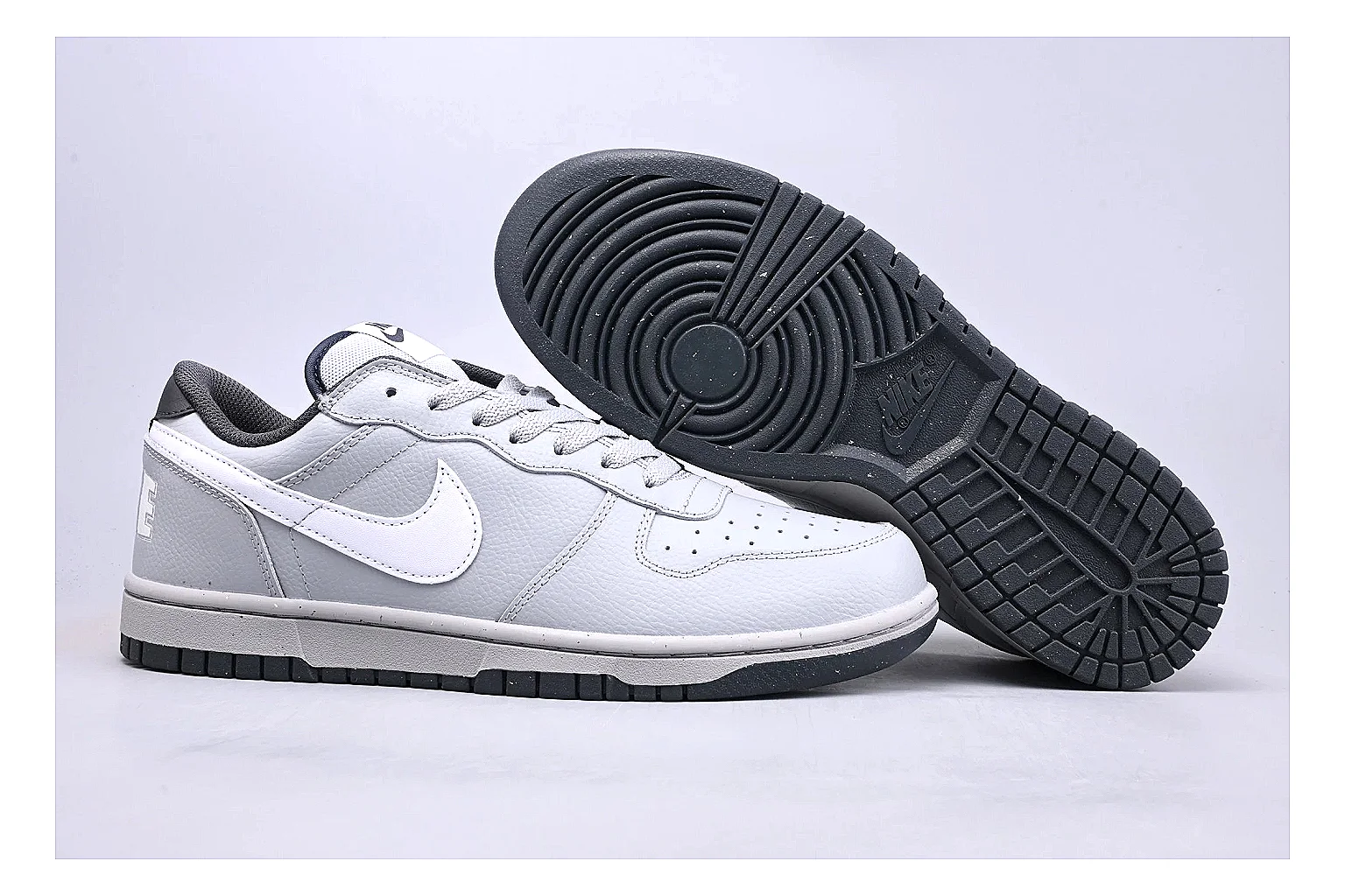 Nike Dunk Low White Gray QC reference photo showing white and gray leather panels, low Dunk shape, padded collar, and basketball-retro sole