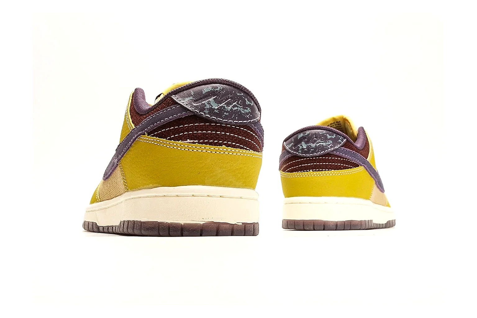 Nike Dunk Low Yellow Purple QC reference photo showing yellow and purple leather panels, dark Swoosh, heel overlay, cream midsole, and brown outsole