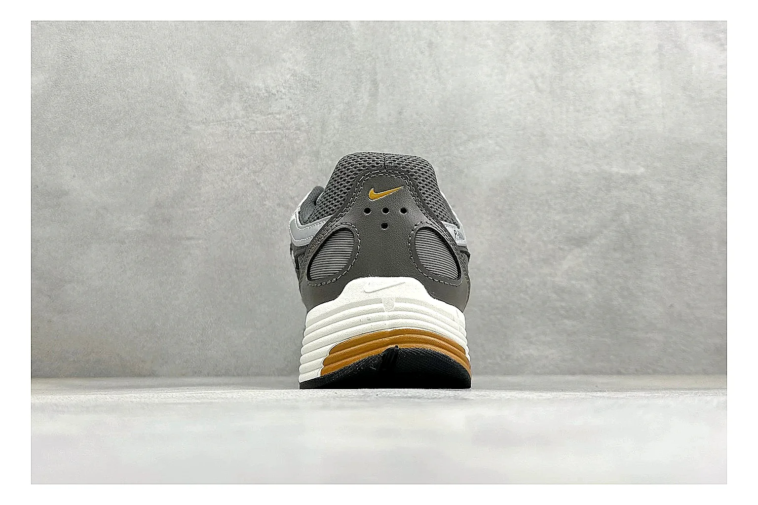 Nike P-6000 Black Orange QC reference photo showing black layered runner upper, orange accent hits, retro P-6000 paneling, and cushioned casual sole