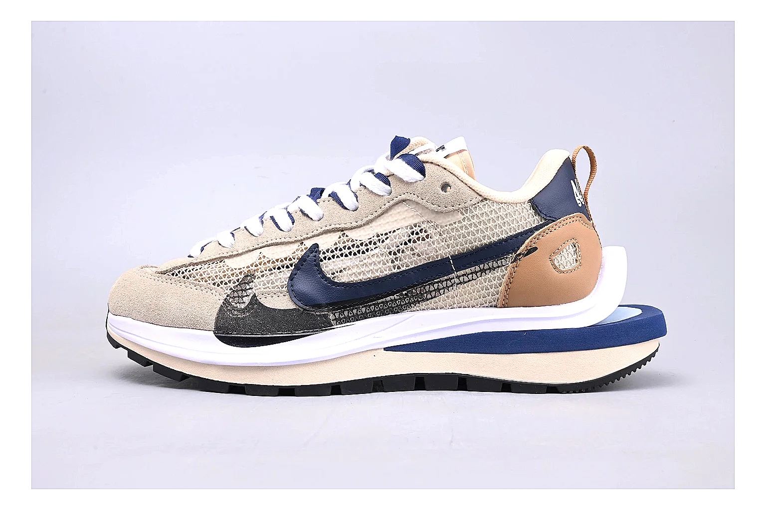 Nike Retro Runner Beige Blue QC reference photo showing beige suede-mesh runner upper, blue accent panels, low retro profile, and cushioned running sole