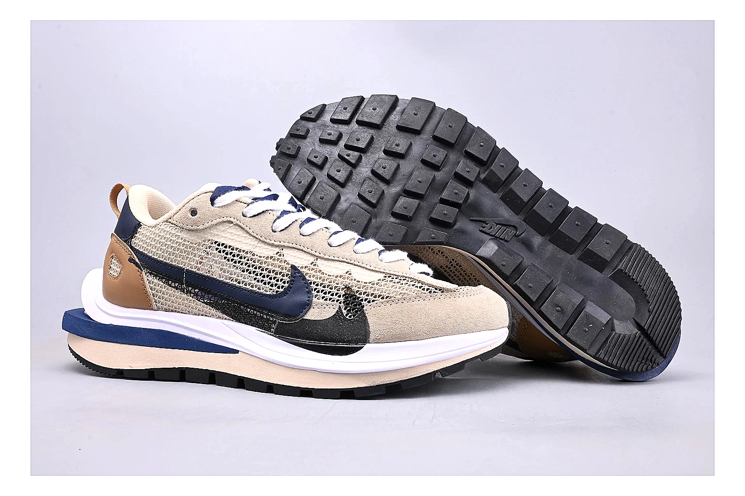 Nike Retro Runner Beige Blue QC reference photo showing beige suede-mesh runner upper, blue accent panels, low retro profile, and cushioned running sole