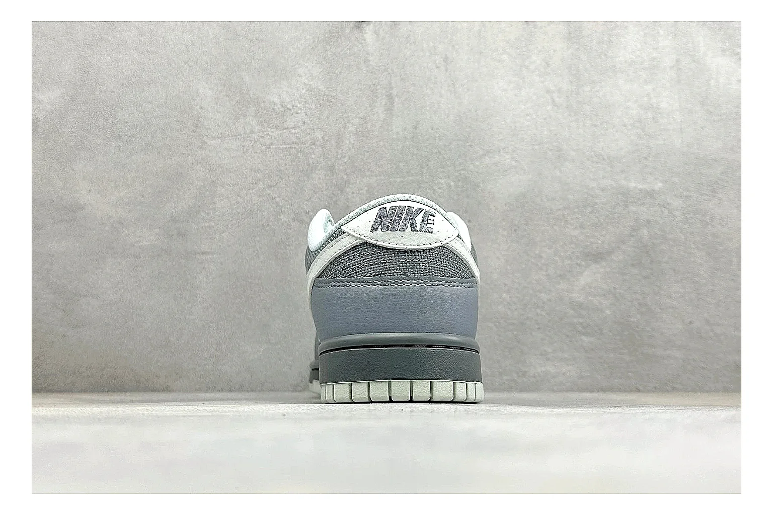 Nike SB Dunk Low Grey QC reference photo showing grey low-top skate upper, white Swoosh, padded collar, and classic Dunk sole