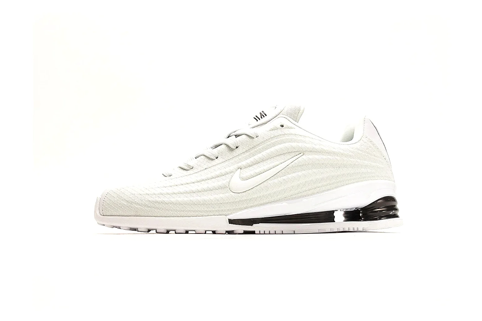 Nike Shox Z White Sneakers QC reference photo showing white streamlined layered upper, small Swoosh, black heel cushioning columns, and modern low runner shape