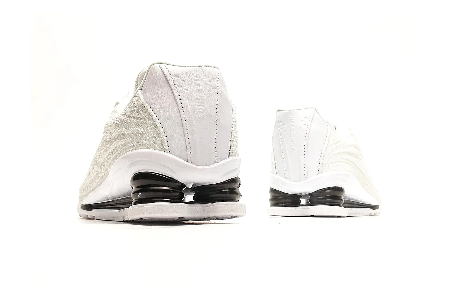 Nike Shox Z White Sneakers QC reference photo showing white streamlined layered upper, small Swoosh, black heel cushioning columns, and modern low runner shape